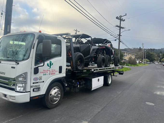 A truck with a atv on the back of it