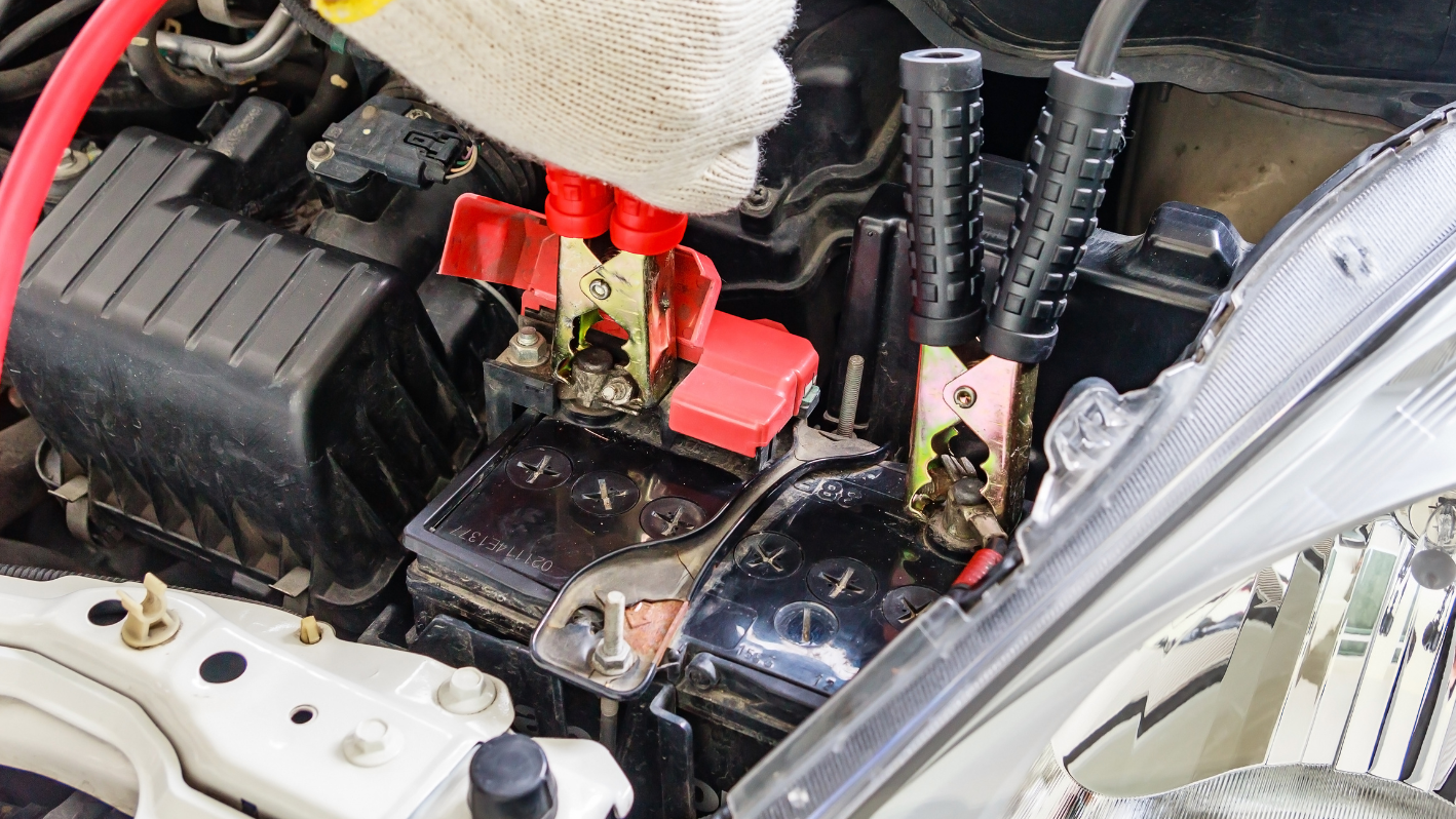 A person is working on a car's engine