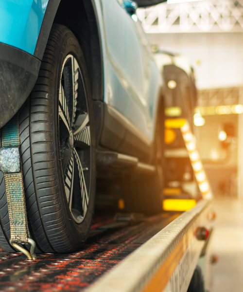 A close up of a car on a tow truck